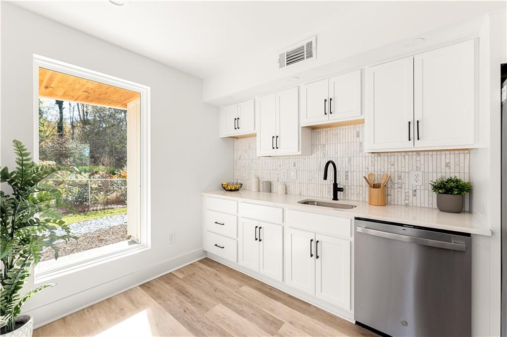 845 Ormewood Terrace Southeast, Unit B Atlanta, GA 30316 - Photo 17 of 32 a kitchen with white cabinets and white appliances
