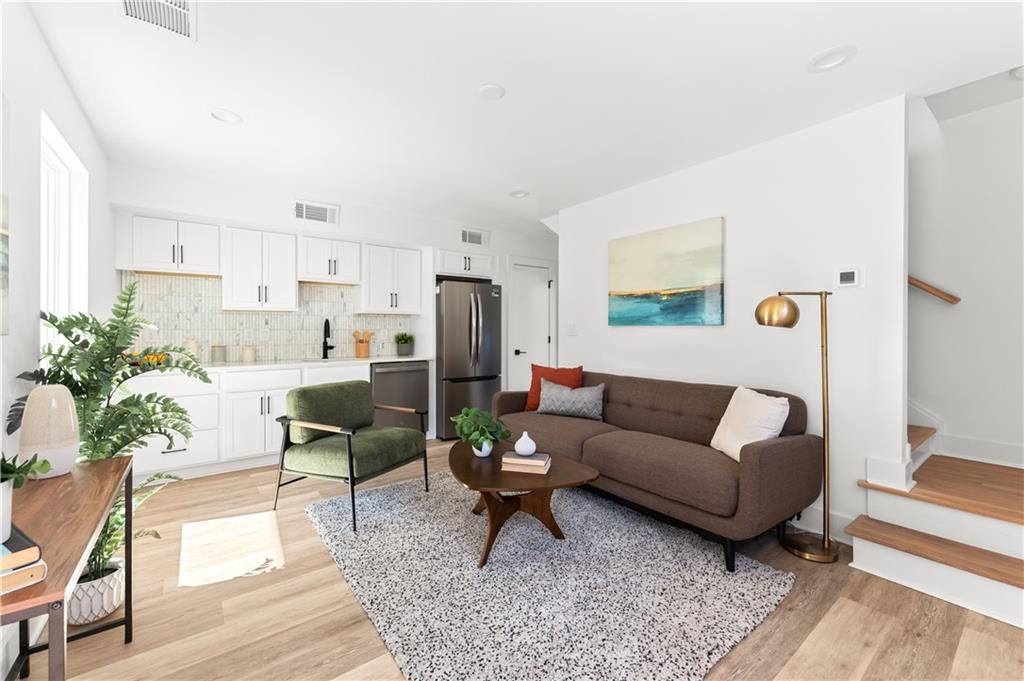 845 Ormewood Terrace Southeast, Unit B Atlanta, GA 30316 - Photo 2 of 32 a living room with furniture a rug and a table