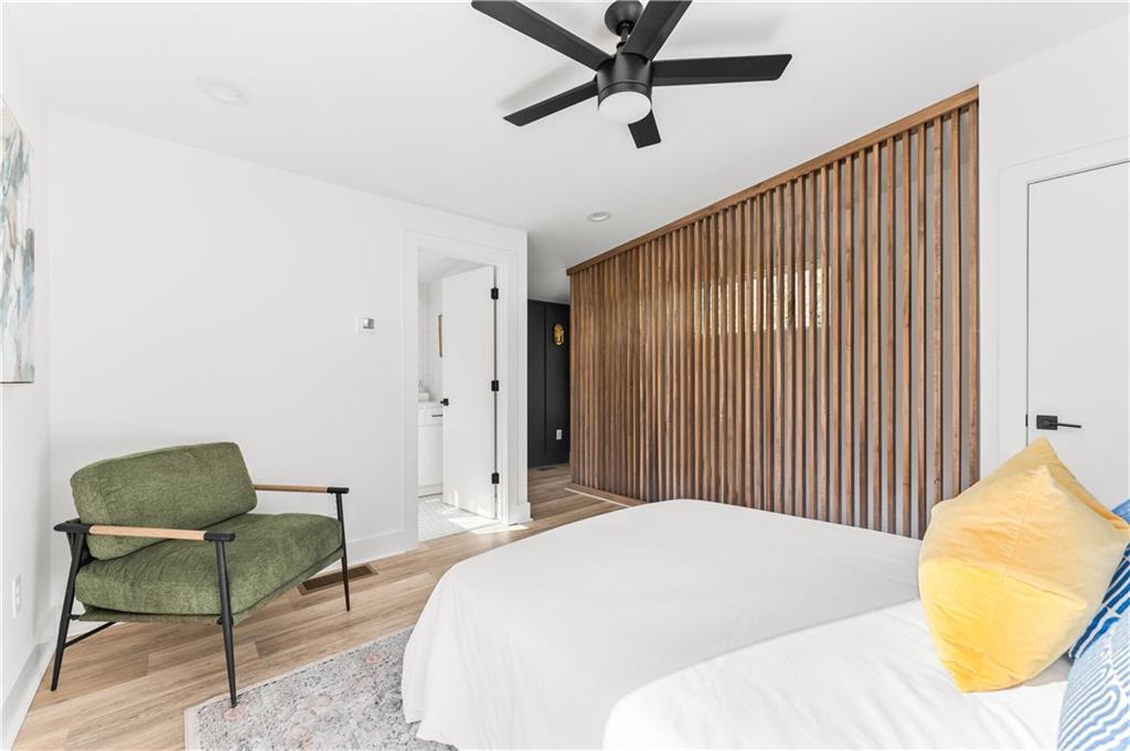 845 Ormewood Terrace Southeast, Unit B Atlanta, GA 30316 - Photo 4 of 32 a spacious bedroom with a bed and a chair