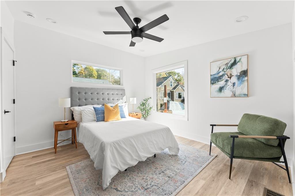 845 Ormewood Terrace Southeast, Unit B Atlanta, GA 30316 - Photo 10 of 32 a bed room with a bed and a chair