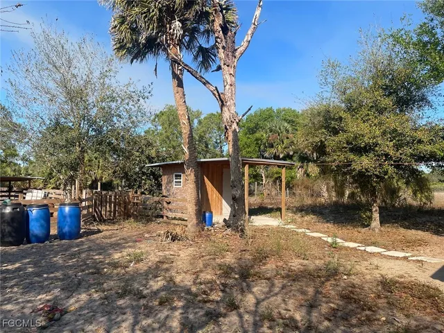 a view of a house with backyard and patio