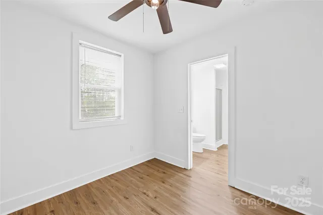 a view of a big house with a big yard and large trees
