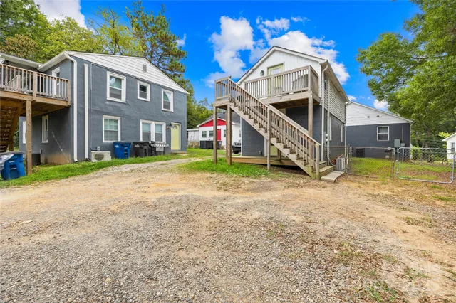 a front view of a house with a yard and balcony