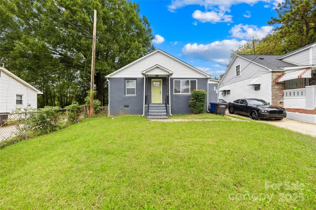 a view of house with garden and car parked