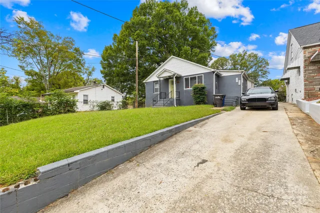 a front view of a house with swimming pool having outdoor seating