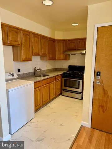a kitchen with a sink a stove and refrigerator