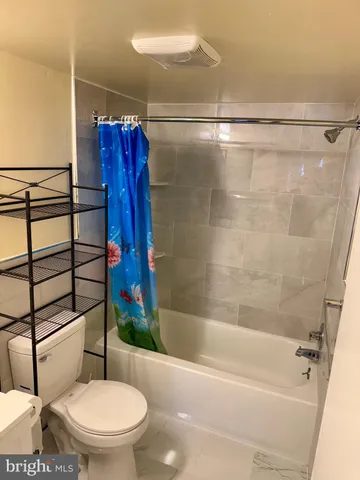 a bathroom with a shower and a toilet
