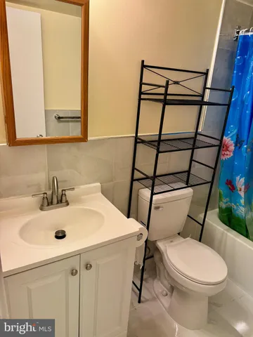 a bathroom with a sink toilet and mirror
