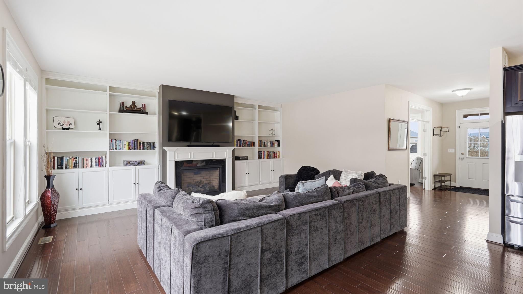 111 Pear Blossom Road Stafford, VA 22554 - Photo 12 of 68 a living room with furniture a flat screen tv and a fireplace