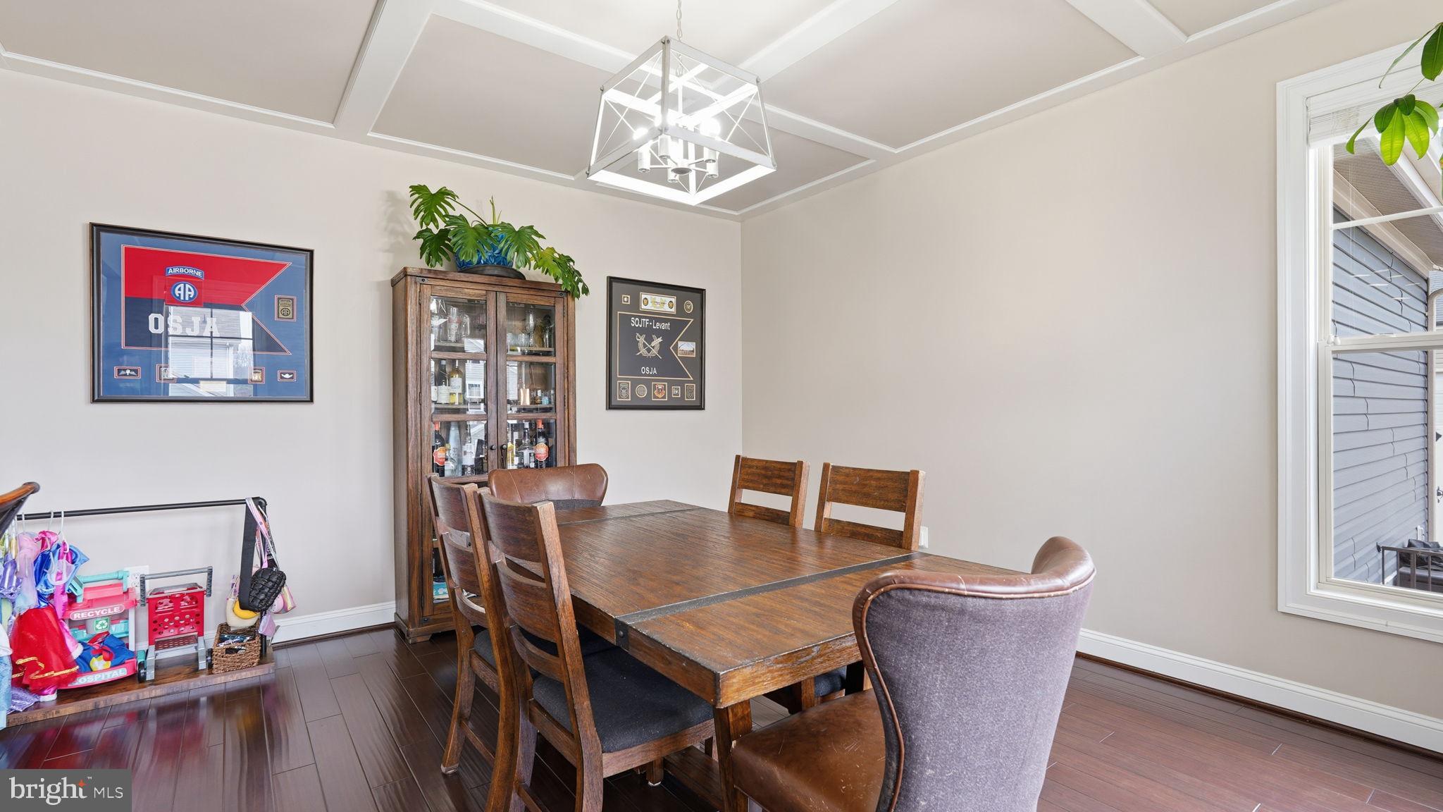 111 Pear Blossom Road Stafford, VA 22554 - Photo 14 of 68 a view of a dining room with furniture a chandelier and wooden floor