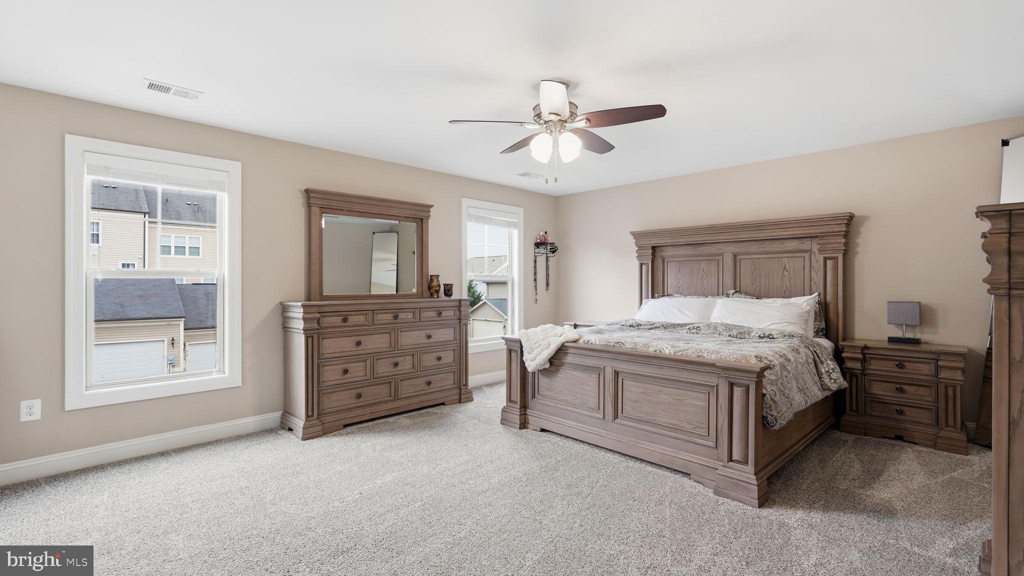 111 Pear Blossom Road Stafford, VA 22554 - Photo 19 of 68 a spacious bedroom with a bed and a chandelier