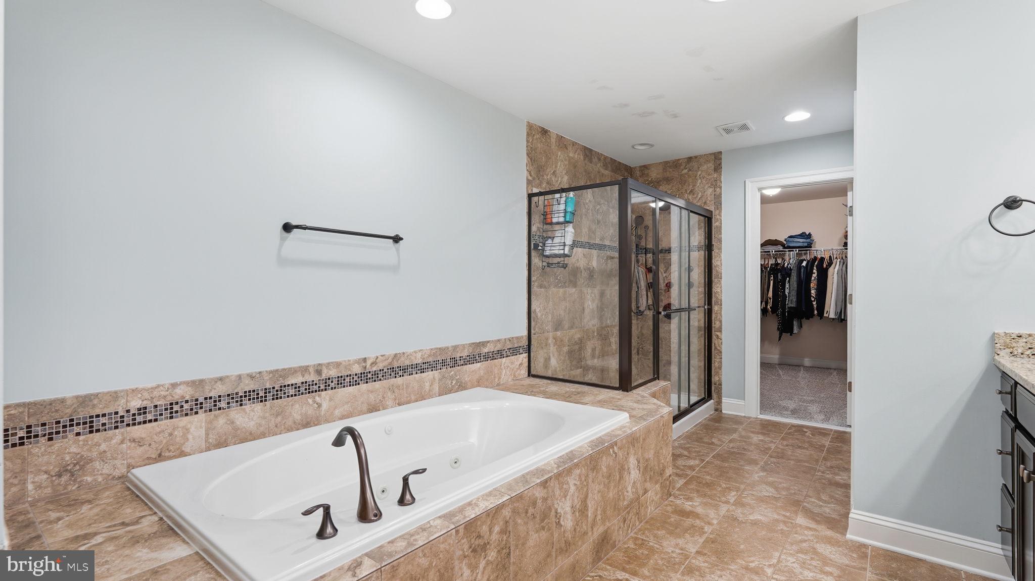 111 Pear Blossom Road Stafford, VA 22554 - Photo 21 of 68 a bathroom with a tub a sink and a shower