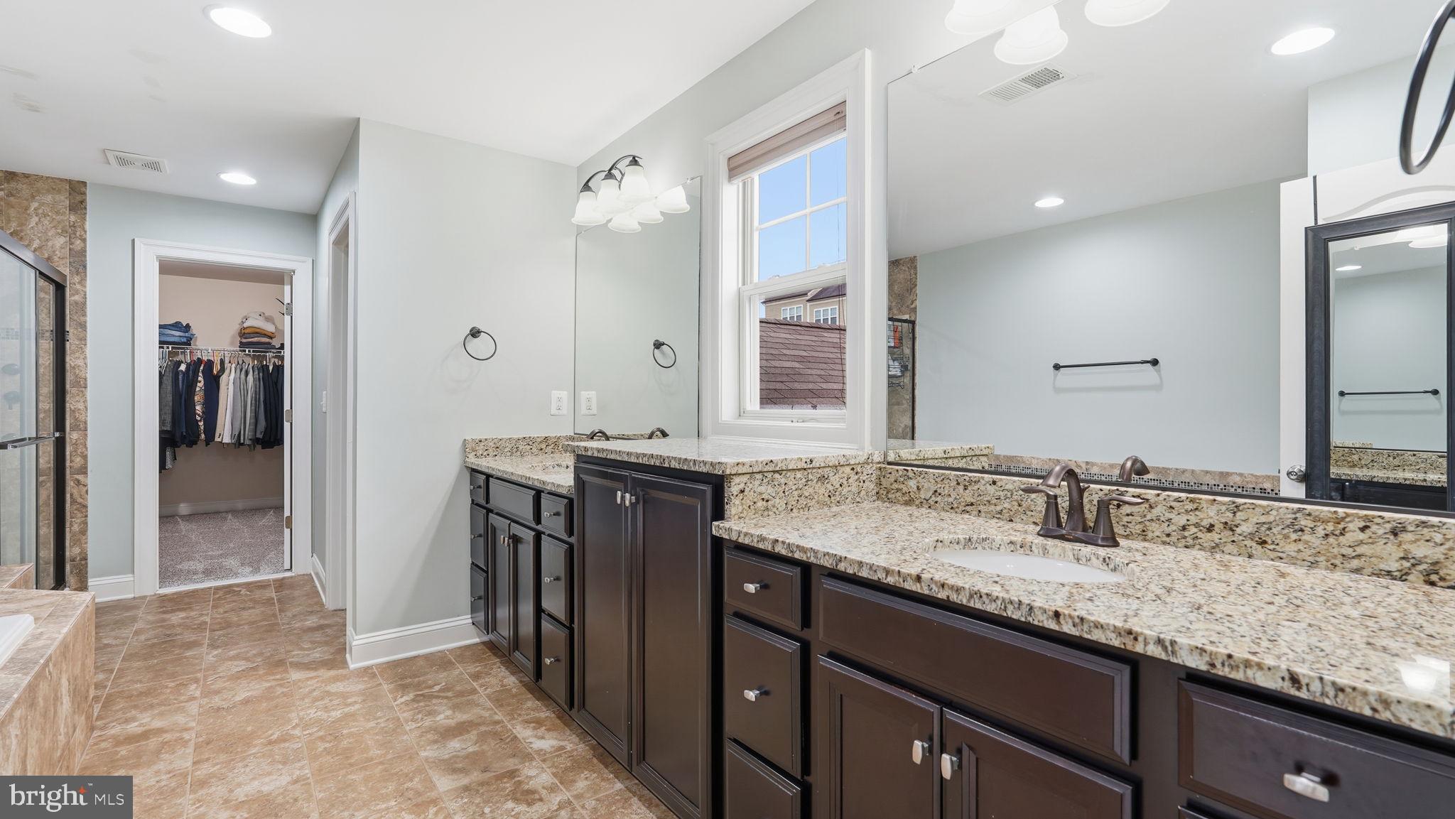 111 Pear Blossom Road Stafford, VA 22554 - Photo 22 of 68 a bathroom with a granite countertop sink and a mirror