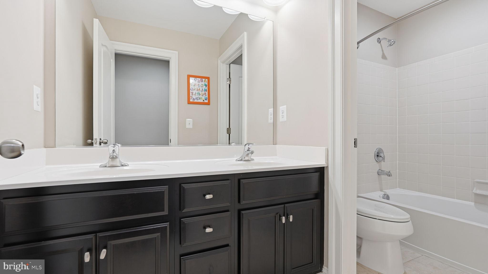 111 Pear Blossom Road Stafford, VA 22554 - Photo 25 of 68 a bathroom with a granite countertop sink a toilet and a mirror
