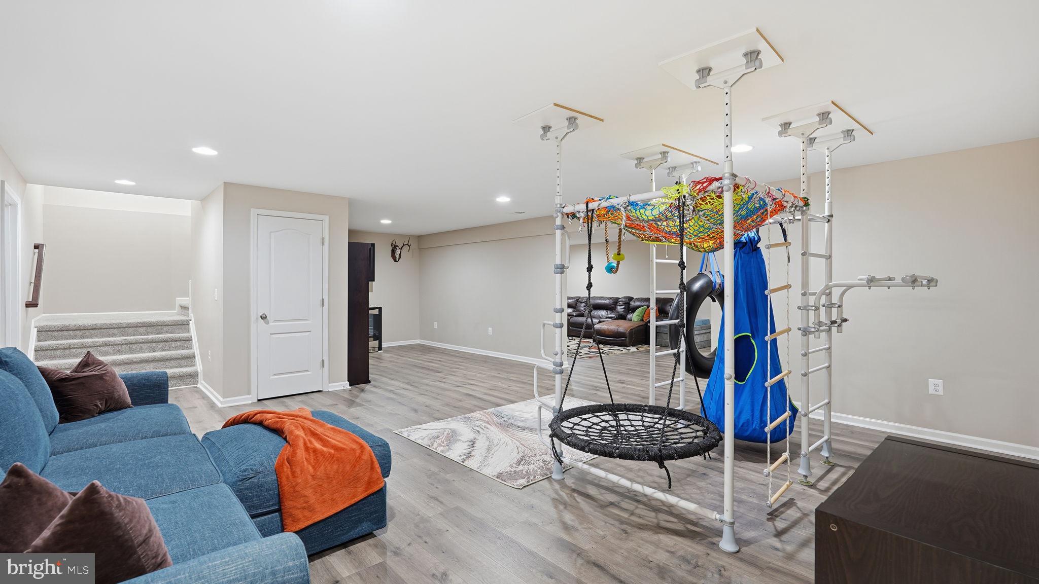 111 Pear Blossom Road Stafford, VA 22554 - Photo 30 of 68 a living room with furniture a ceiling fan and a rug