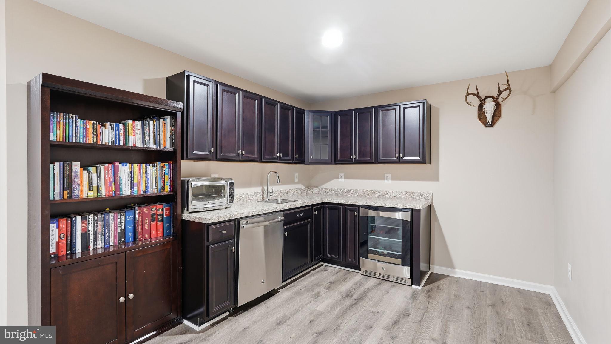 111 Pear Blossom Road Stafford, VA 22554 - Photo 31 of 68 a kitchen with a stove cabinets and a book shelf