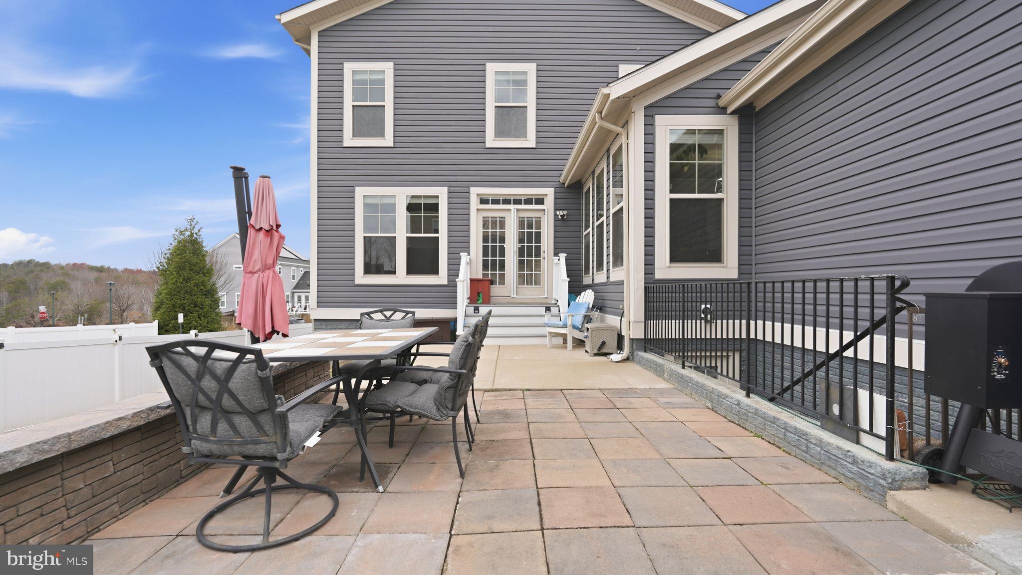 111 Pear Blossom Road Stafford, VA 22554 - Photo 36 of 68 a view of a patio with table and chairs and potted plants