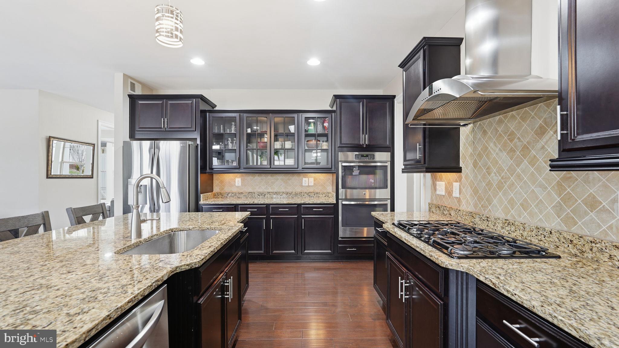 111 Pear Blossom Road Stafford, VA 22554 - Photo 10 of 68 a kitchen with stainless steel appliances granite countertop a sink stove and refrigerator