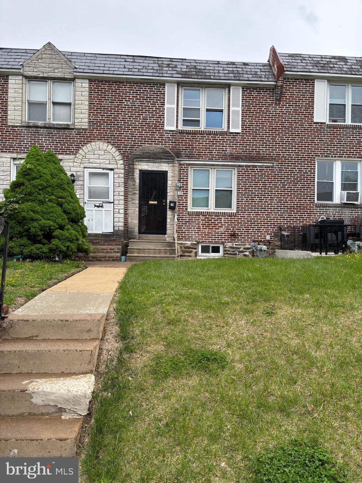 18 Southridge Road Darby, PA 19023 - Photo 1 of 13 a front view of a house with a yard and garage