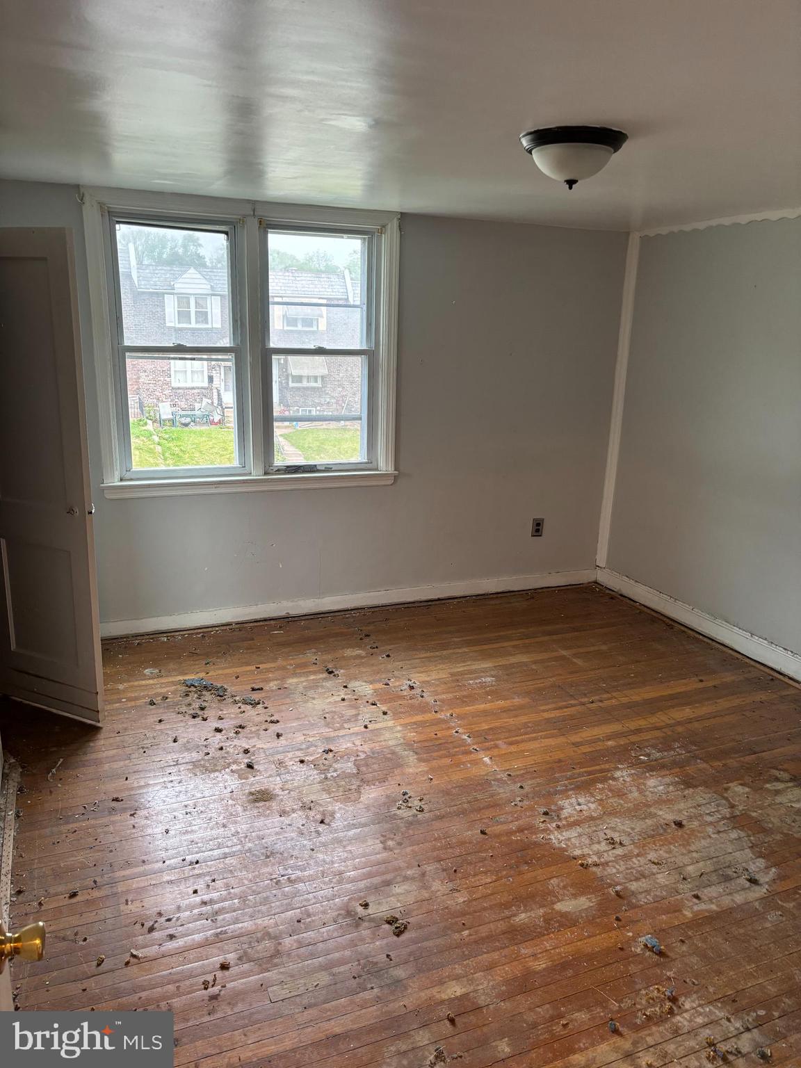18 Southridge Road Darby, PA 19023 - Photo 10 of 13 an empty room with wooden floor and windows