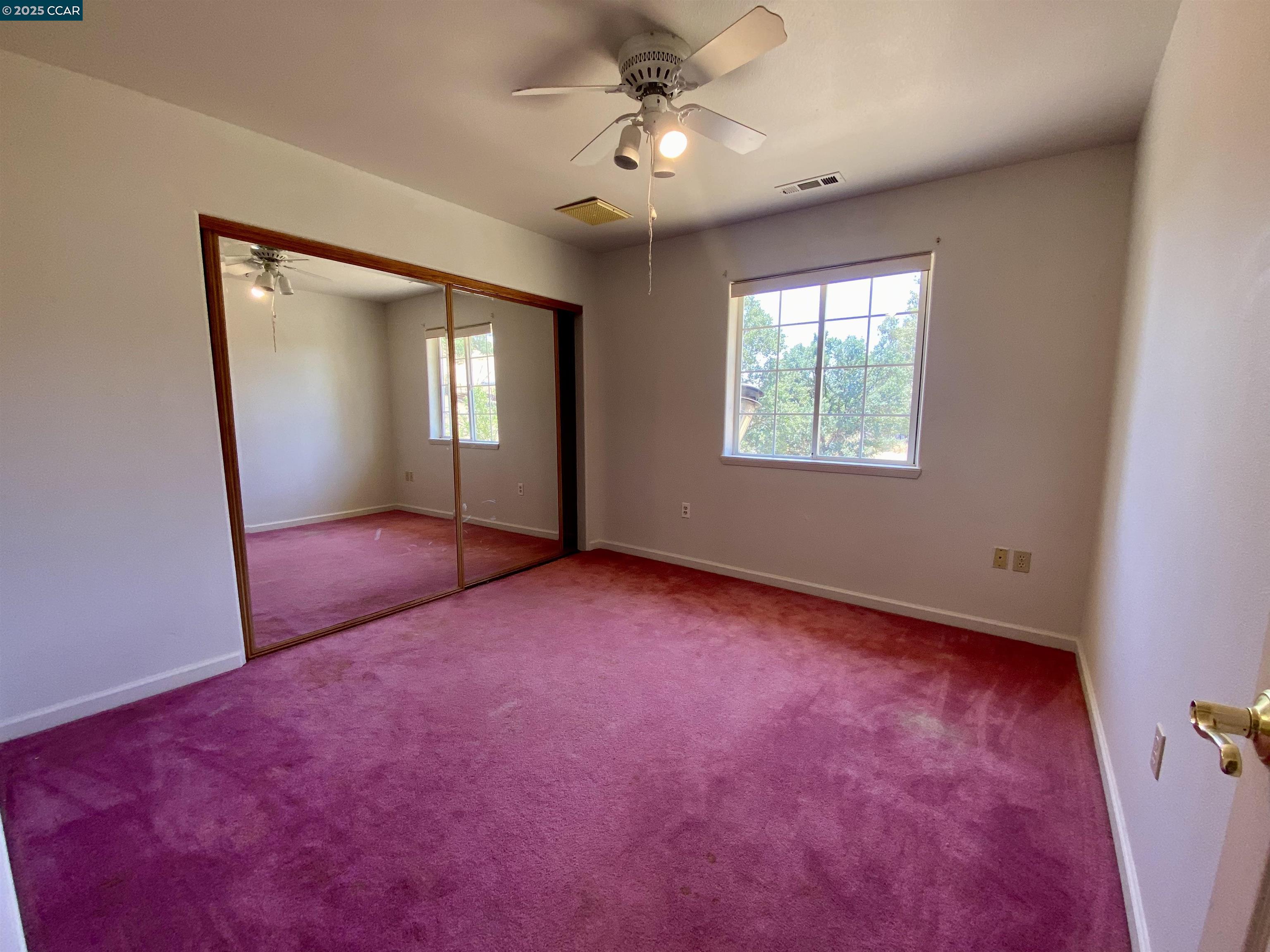 2707 River View Road Clearlake Oaks, CA 95423 - Photo 11 of 18 an empty room with windows and fan
