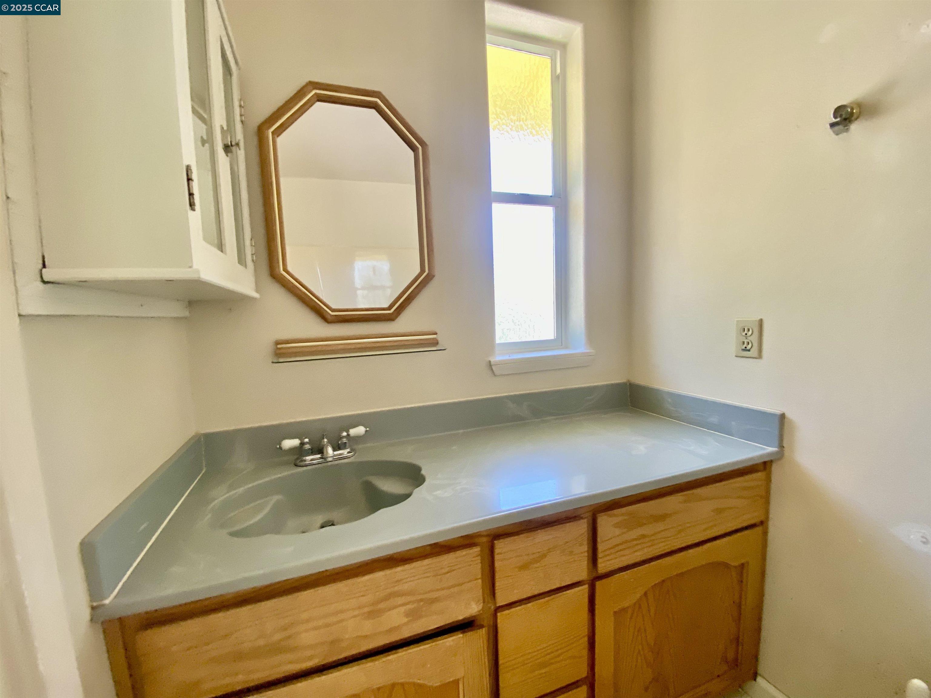 2707 River View Road Clearlake Oaks, CA 95423 - Photo 14 of 18 a bathroom with a sink and a mirror