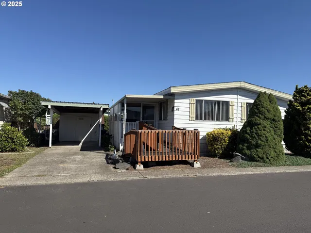 a view of a house with a wooden fence