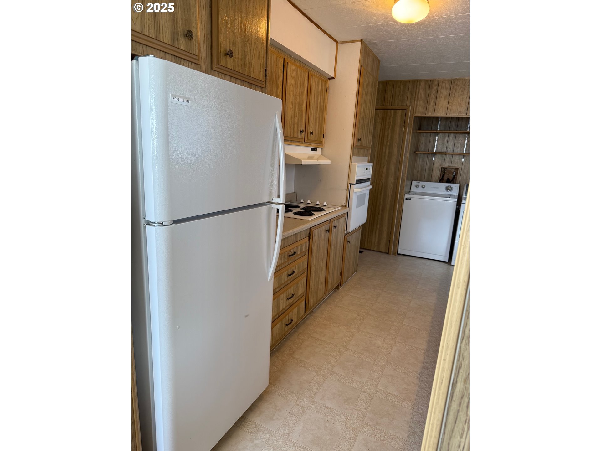5422 Portland Road Northeast, Unit 47 Salem, OR 97305 - Photo 11 of 45 a kitchen with a refrigerator and a stove