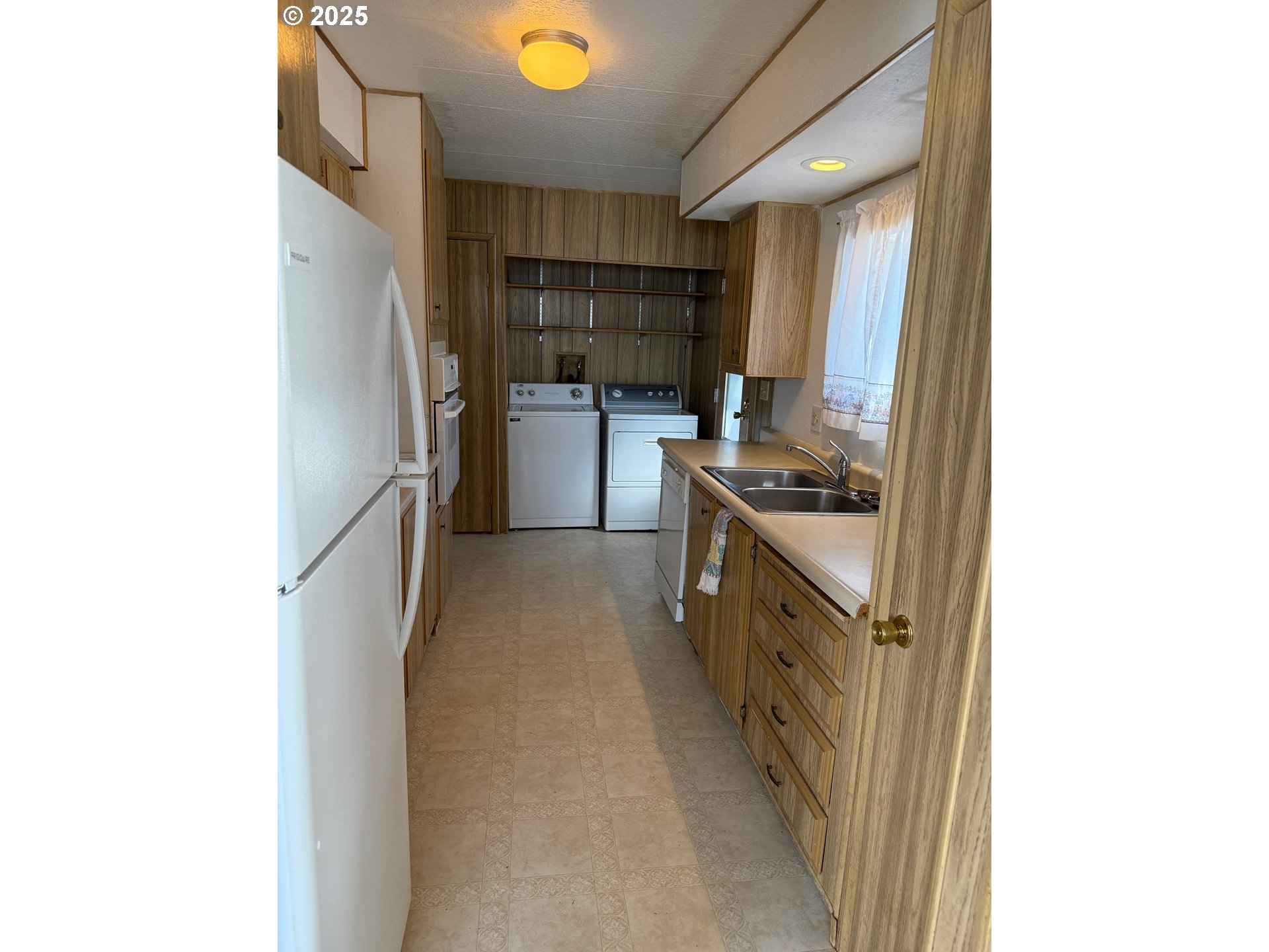 5422 Portland Road Northeast, Unit 47 Salem, OR 97305 - Photo 12 of 45 a kitchen with a sink and refrigerator