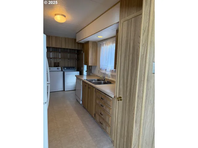 a kitchen with stainless steel appliances granite countertop a sink and cabinets