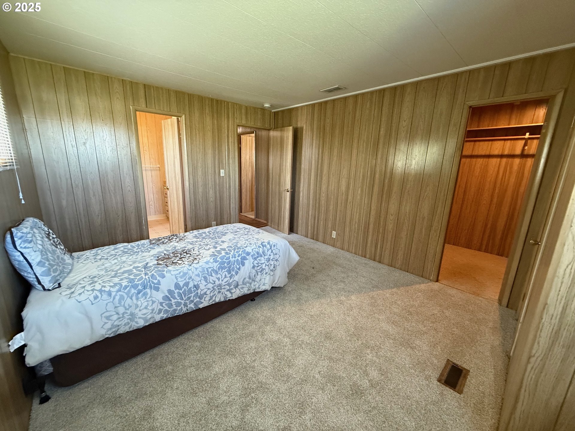 5422 Portland Road Northeast, Unit 47 Salem, OR 97305 - Photo 22 of 45 a bedroom with a bed and a mirror