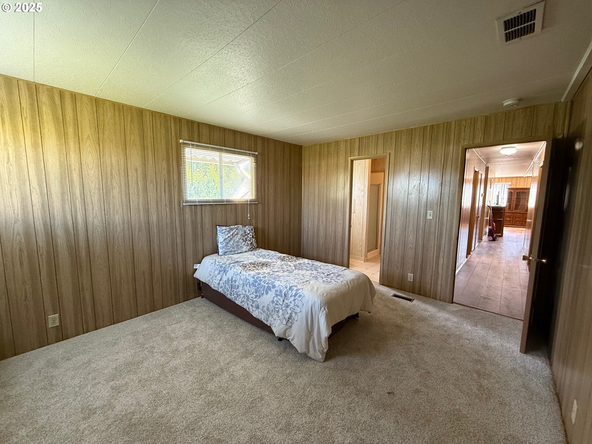 5422 Portland Road Northeast, Unit 47 Salem, OR 97305 - Photo 23 of 45 a spacious bedroom with a bed and a mirror
