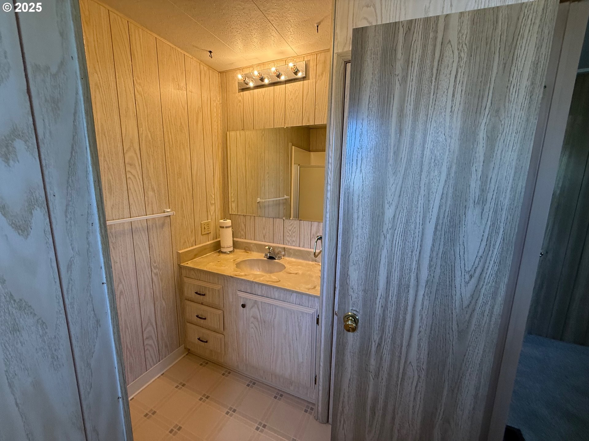 5422 Portland Road Northeast, Unit 47 Salem, OR 97305 - Photo 24 of 45 a bathroom with a sink a mirror and a shower