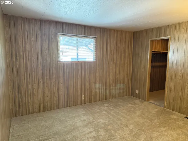 a view of an empty room with wooden door