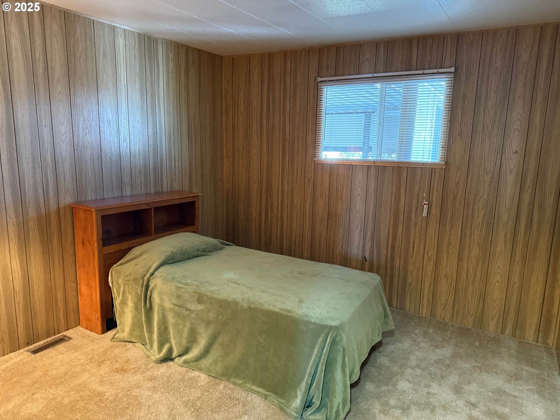 5422 Portland Road Northeast, Unit 47 Salem, OR 97305 - Photo 34 of 45 a bedroom with a bed and a window