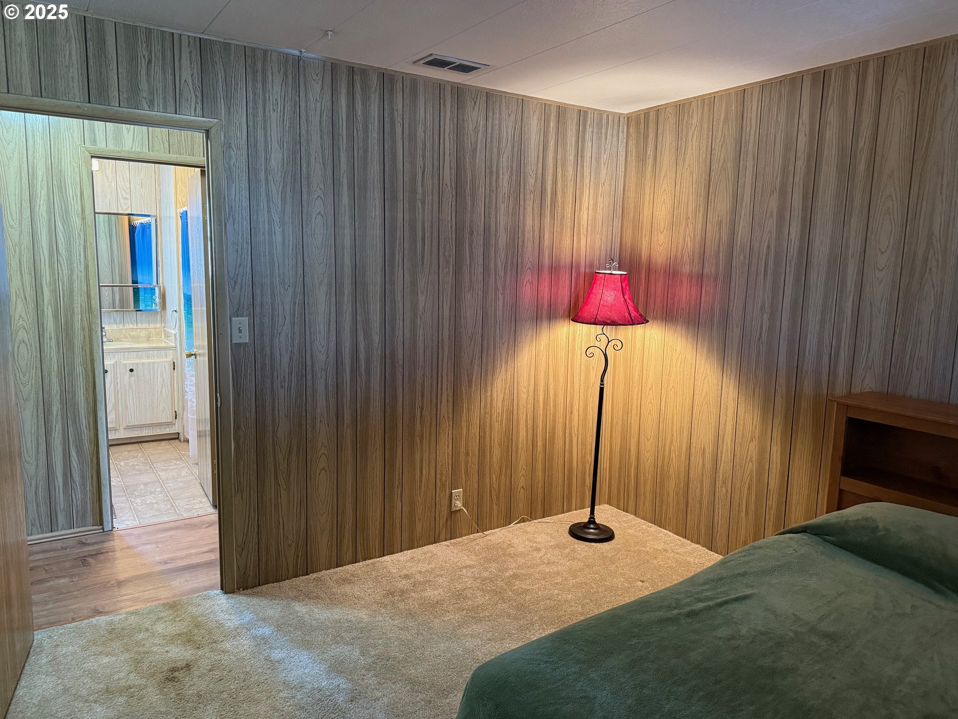 5422 Portland Road Northeast, Unit 47 Salem, OR 97305 - Photo 35 of 45 a bedroom with a bed and a chandelier