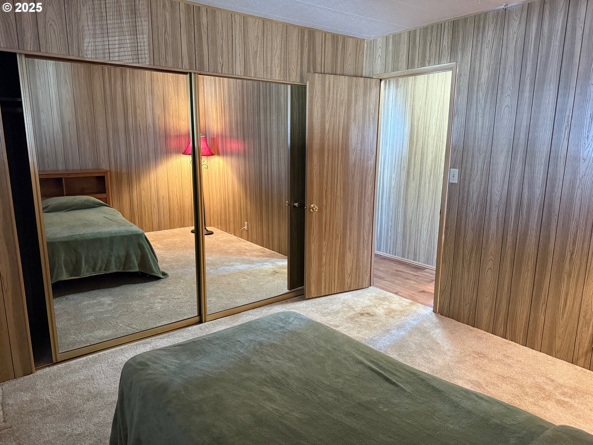 5422 Portland Road Northeast, Unit 47 Salem, OR 97305 - Photo 36 of 45 a bedroom with a bed and a mirror