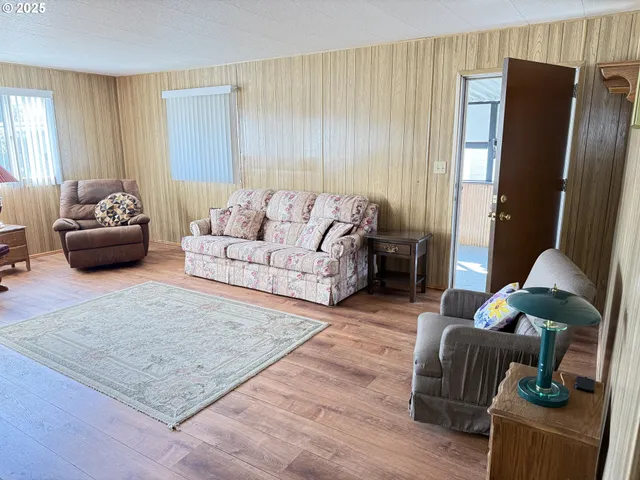 a living room with furniture rug and a window