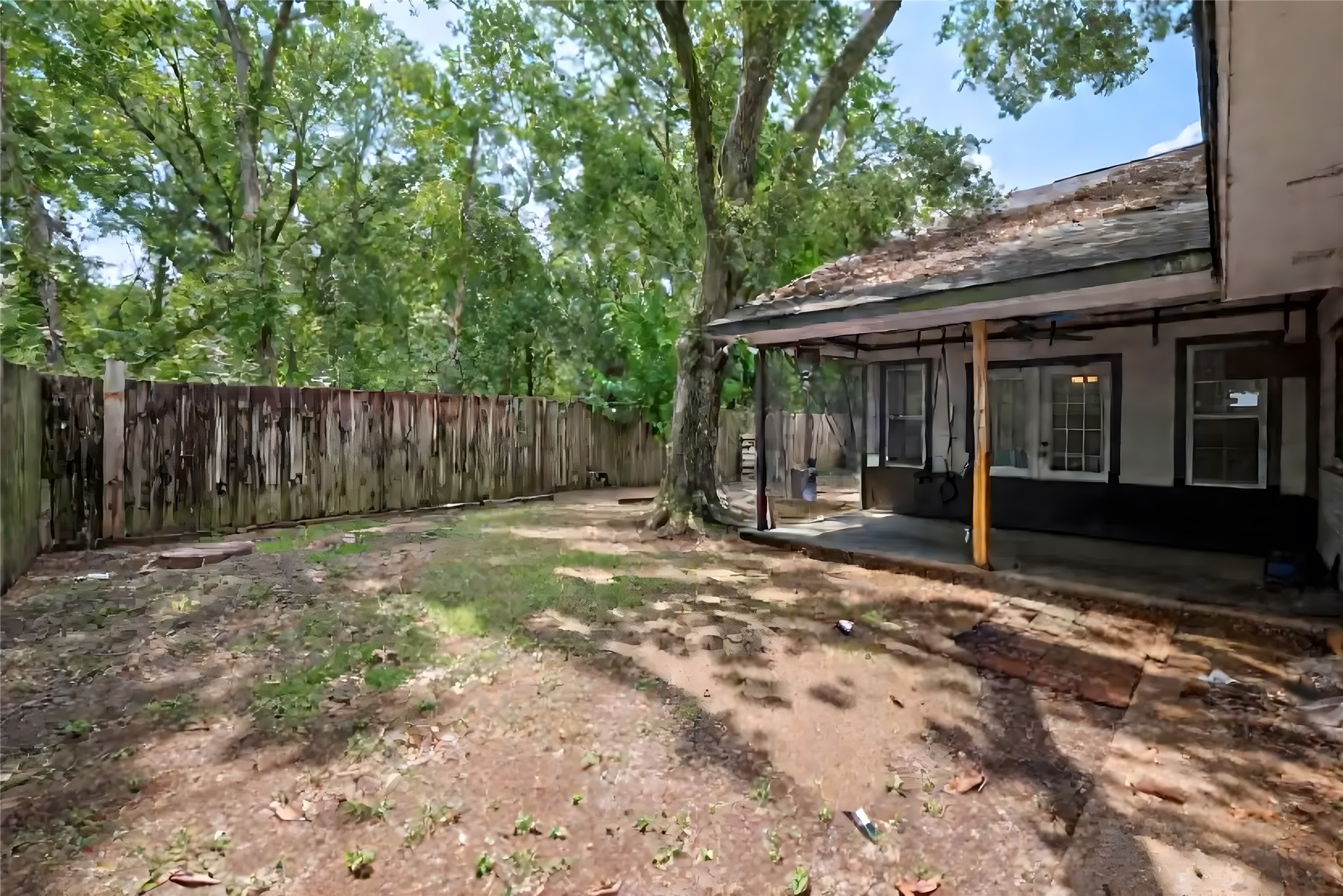7706 Ashmole Lane Houston, TX 77088 - Photo 16 of 16 Large fully fenced backyard with ample room to customize, garden, or add outdoor amenities. Mature trees create natural shade and a peaceful setting.