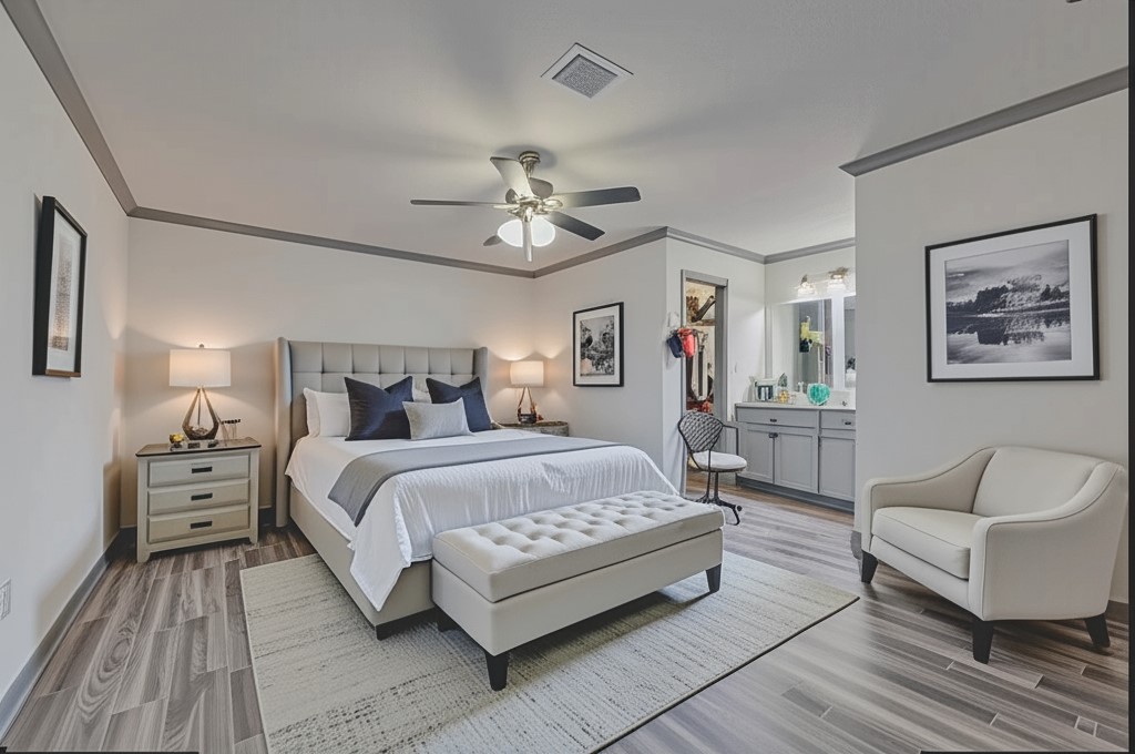 7706 Ashmole Lane Houston, TX 77088 - Photo 8 of 16 This inviting primary bedroom offers a bright, open layout with updated flooring and chic décor. A private vanity nook and walk-in closet complete the retreat.