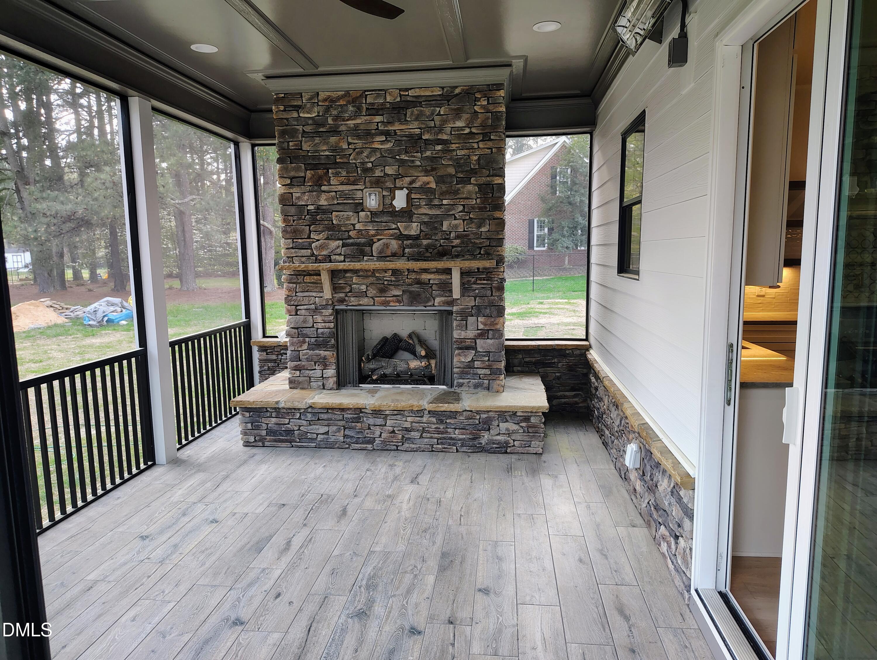 4009 Yates Mill Pond Road Raleigh, NC 27606 - Photo 12 of 52 a living room with wooden floor and a fireplace