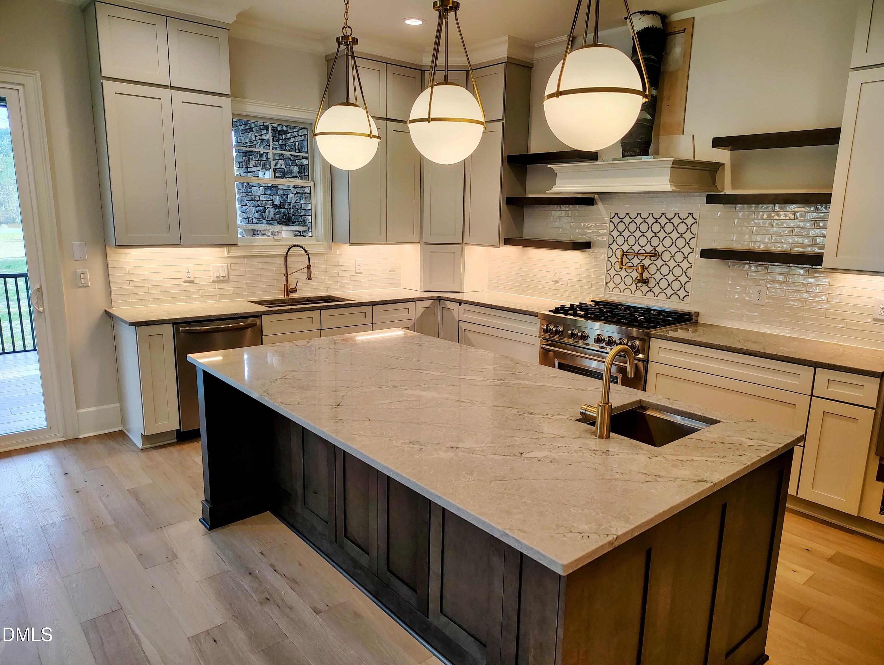 4009 Yates Mill Pond Road Raleigh, NC 27606 - Photo 19 of 52 a kitchen with kitchen island a sink and wooden floor