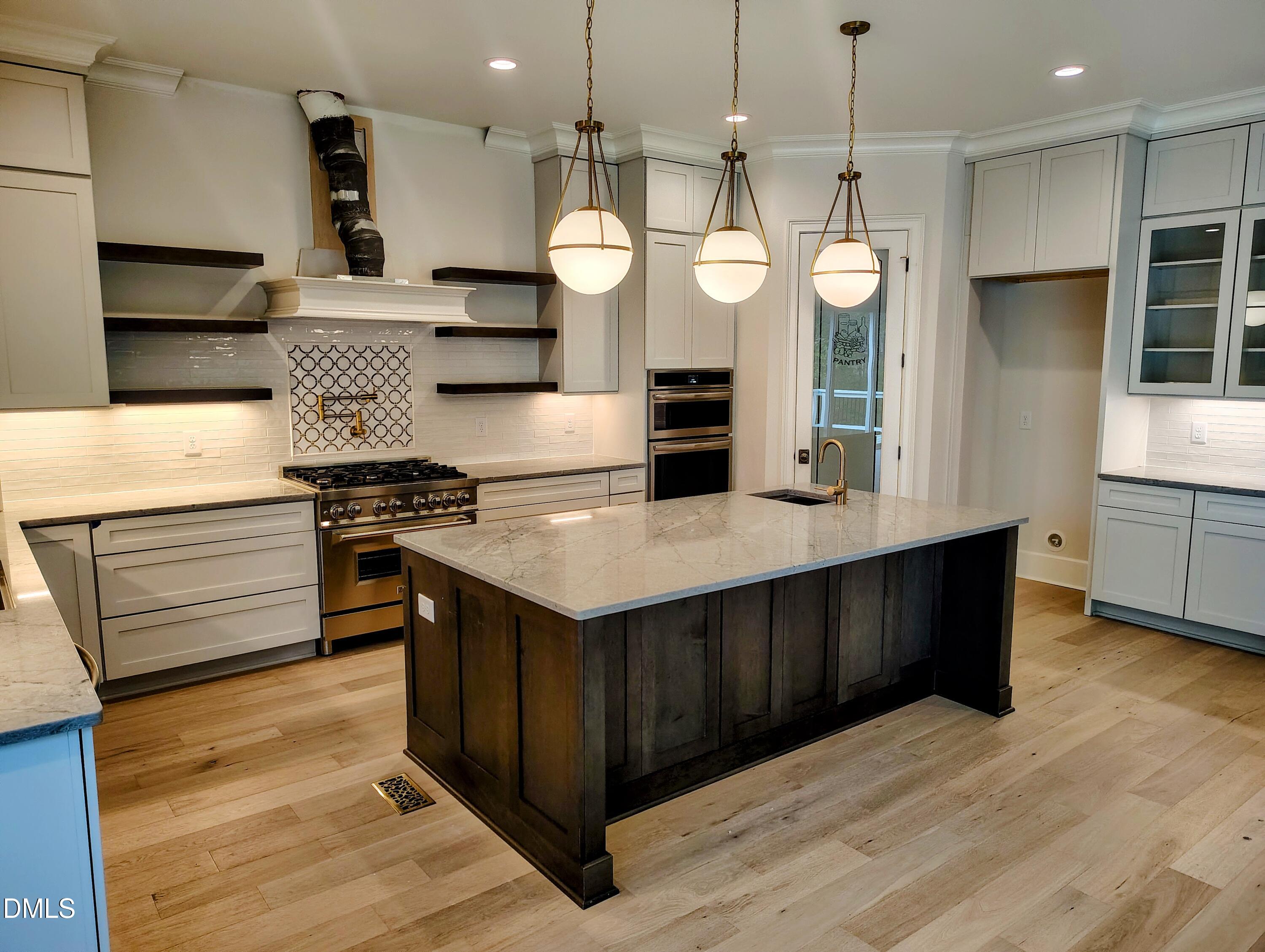 4009 Yates Mill Pond Road Raleigh, NC 27606 - Photo 20 of 52 a kitchen with stainless steel appliances granite countertop a stove a sink and a wooden floors