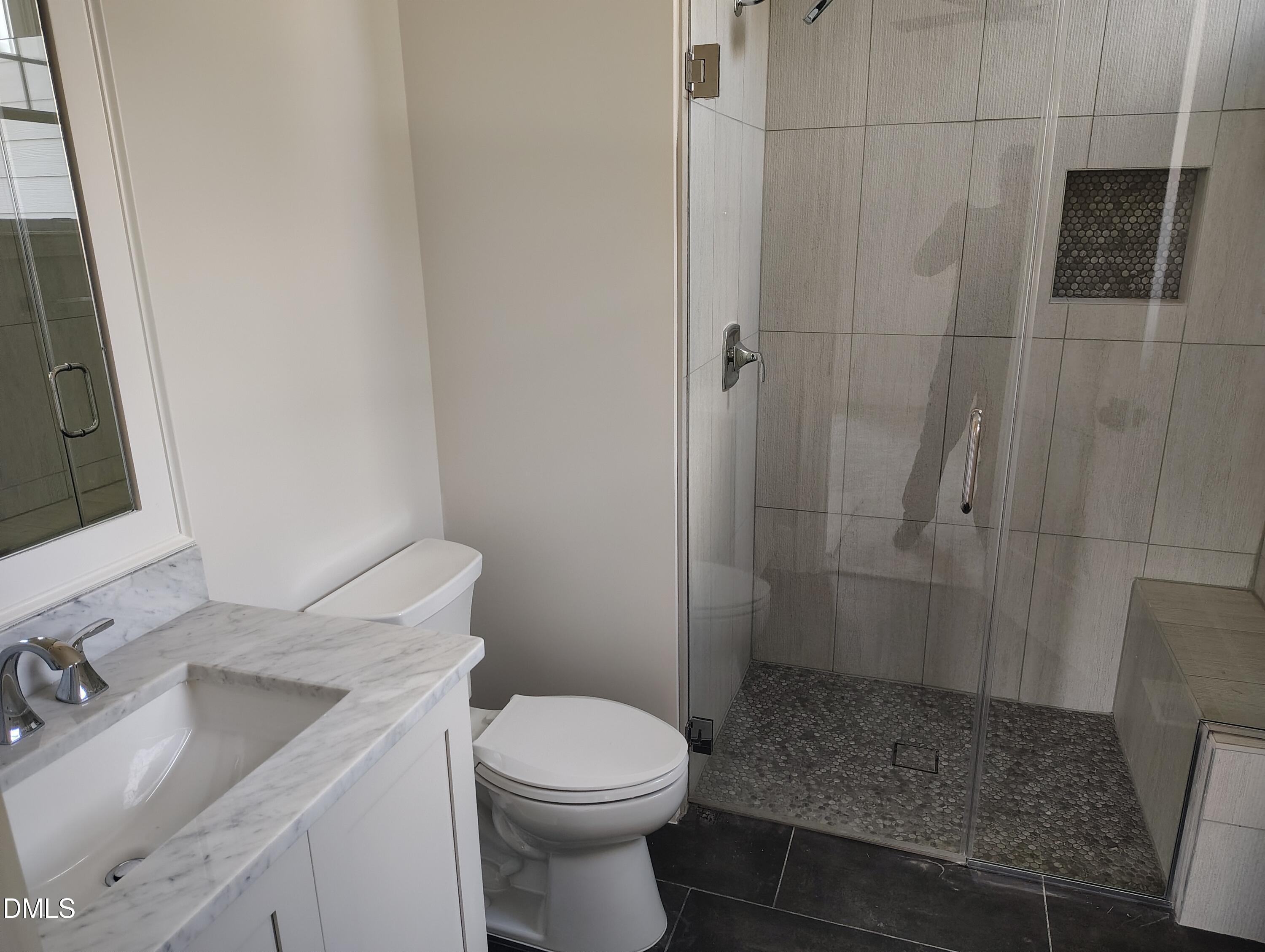 4009 Yates Mill Pond Road Raleigh, NC 27606 - Photo 32 of 52 a bathroom with a sink a toilet and shower