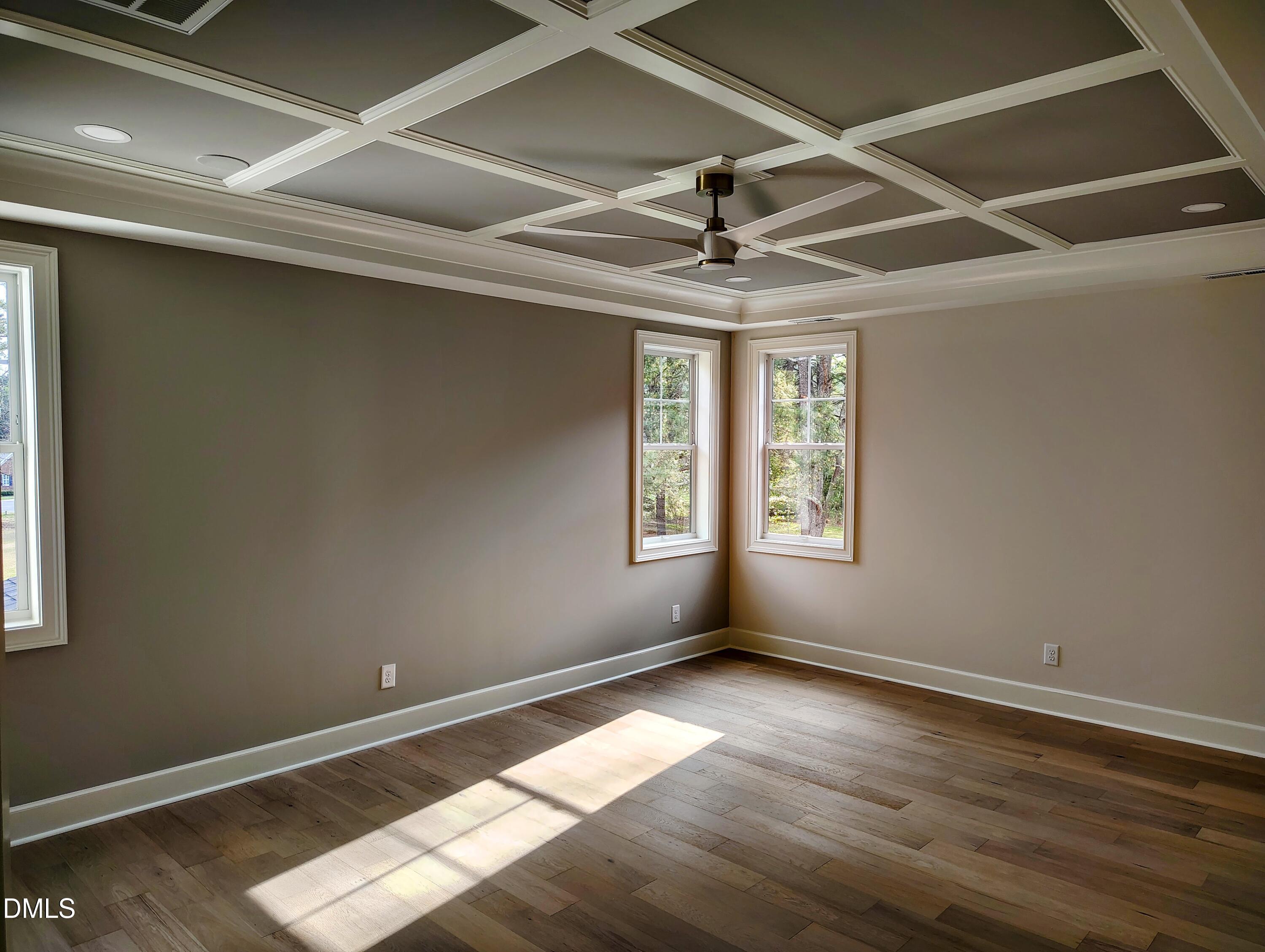4009 Yates Mill Pond Road Raleigh, NC 27606 - Photo 33 of 52 an empty room with wooden floor and windows