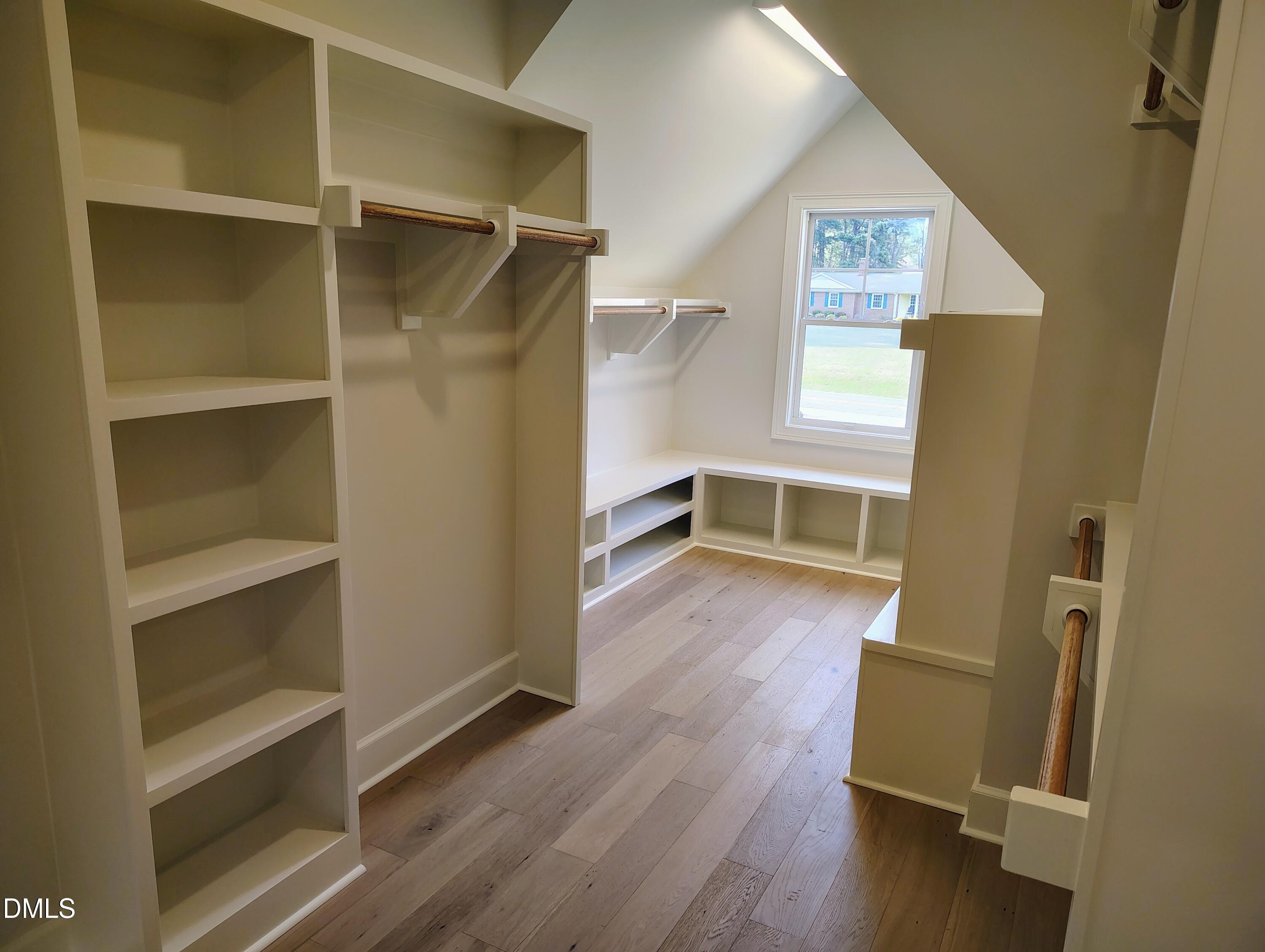 4009 Yates Mill Pond Road Raleigh, NC 27606 - Photo 37 of 52 a view of walk in closet with wooden floor and window
