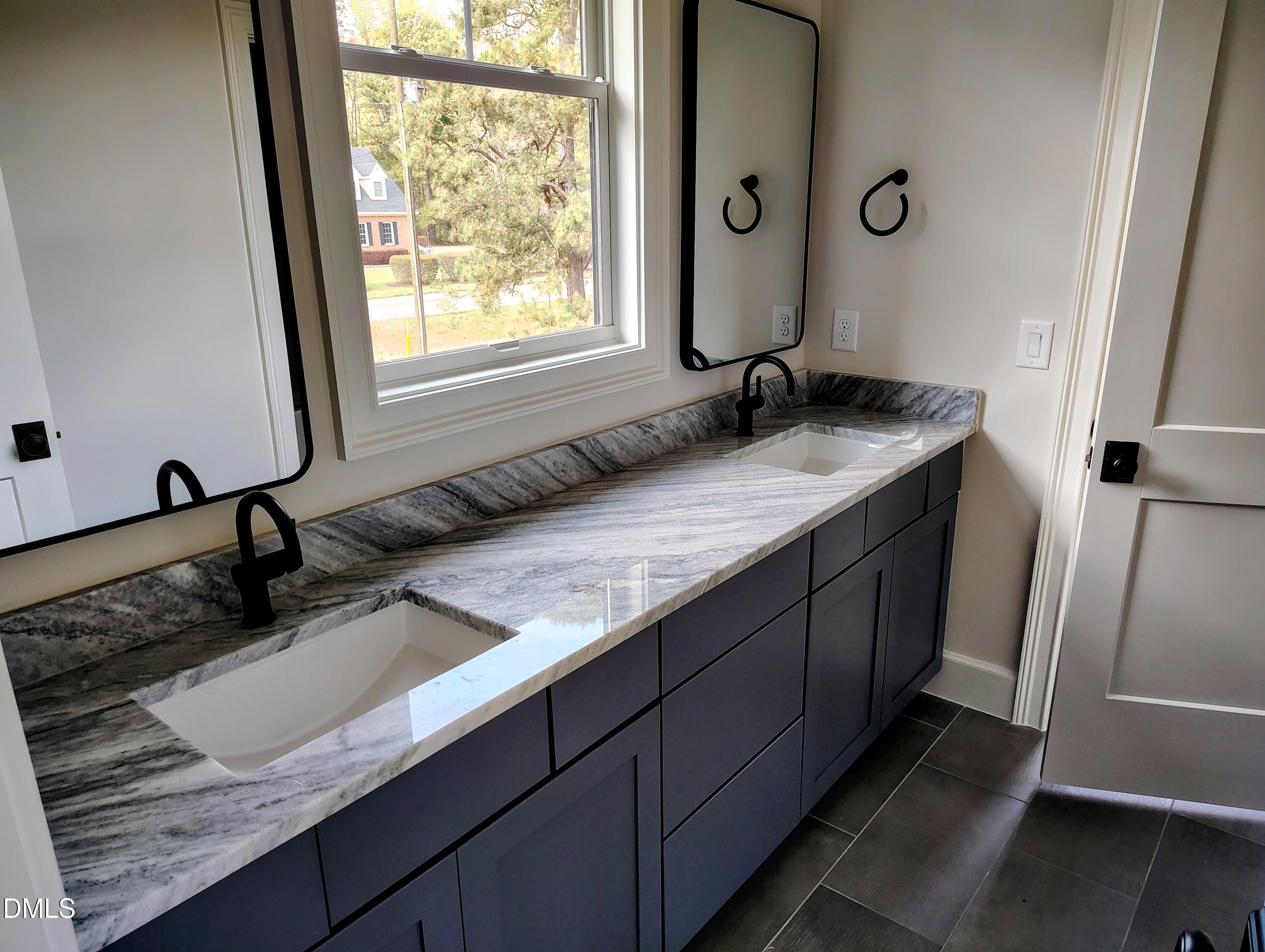 4009 Yates Mill Pond Road Raleigh, NC 27606 - Photo 42 of 52 a bathroom with a granite countertop sink and a mirror