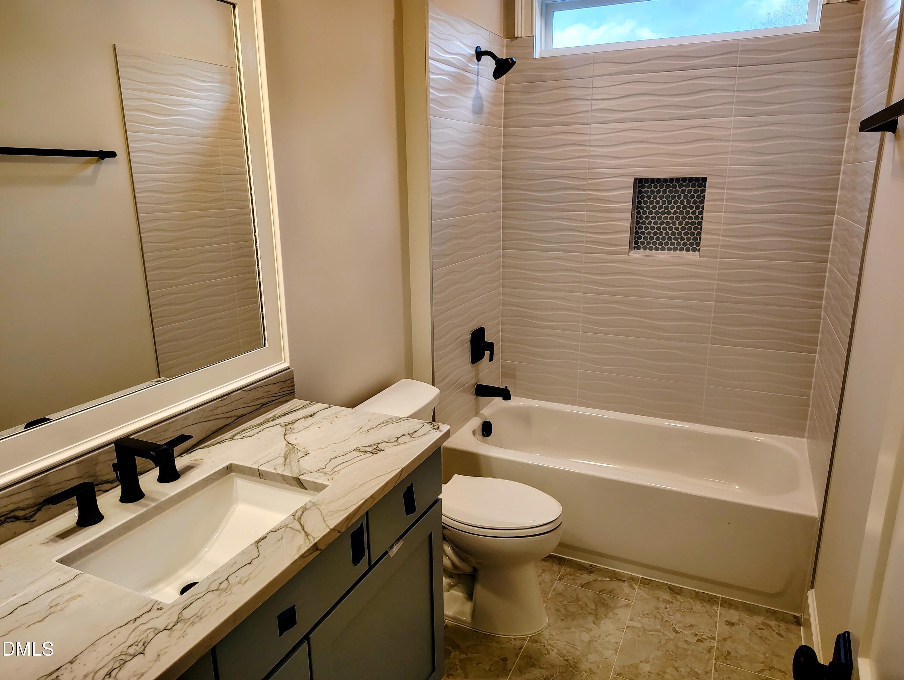 4009 Yates Mill Pond Road Raleigh, NC 27606 - Photo 45 of 52 a bathroom with a sink a toilet a mirror and shower