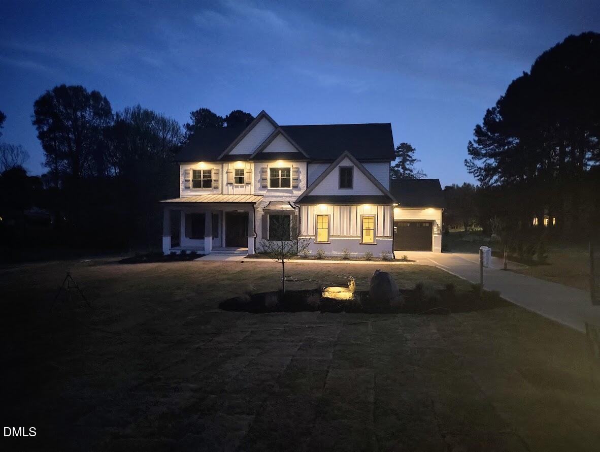 4009 Yates Mill Pond Road Raleigh, NC 27606 - Photo 6 of 52 a view of a house with a yard and a garden
