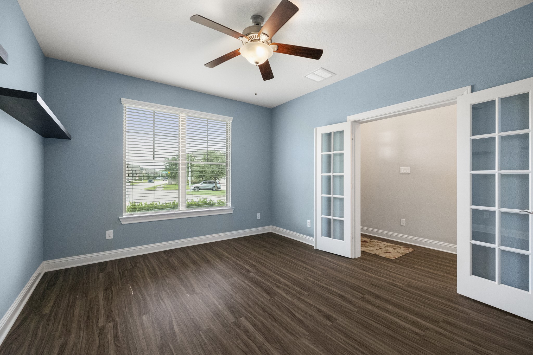 7502 Windsor Park Court Spring, TX 77379 - Photo 7 of 50 an empty room with wooden floor and windows